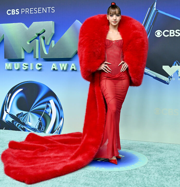 Red carpet VMAs look with long red dress and voluminous red fur coat