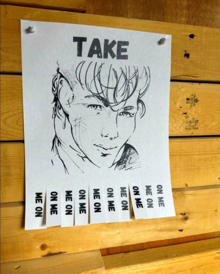 A funny sign with a drawing of a man, offering tear-off tabs that read On Me, like a-ha's song Take On Me.