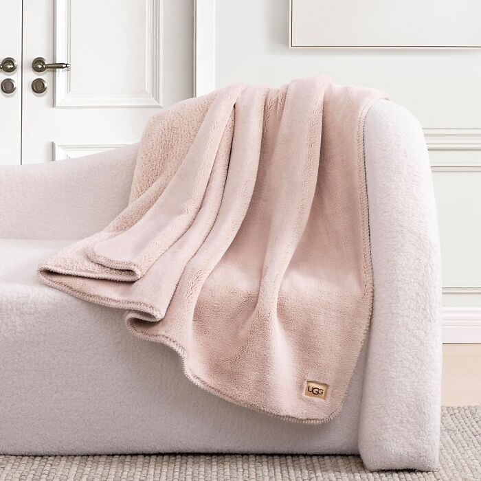 Soft UGG blanket draped over a cozy chair, a top pick from Prime Big Deal Days.