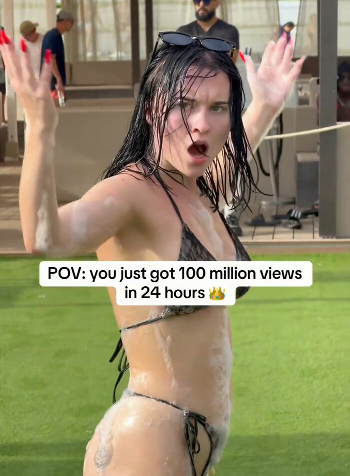 A girl in a red bikini with an excited expression, hands up, covered in foam, celebrating earning an exorbitant amount. A girl in a red bikini with an excited expression, hands up, covered in foam, celebrating earning an exorbitant amount.