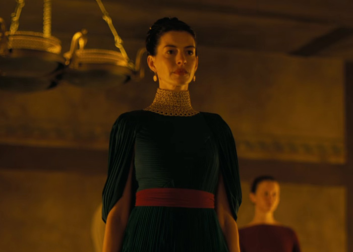 Anne Hathaway in a dark green dress, representing a discussion on Hollywood's plastic surgery obsession