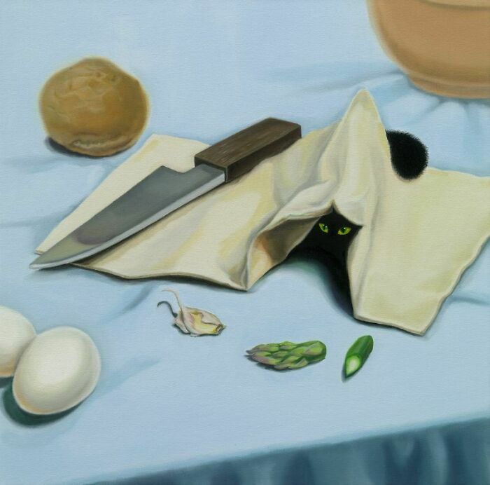 A black cat peeking from a napkin with green eyes, creating a surreal moment in a kitchen setting.
