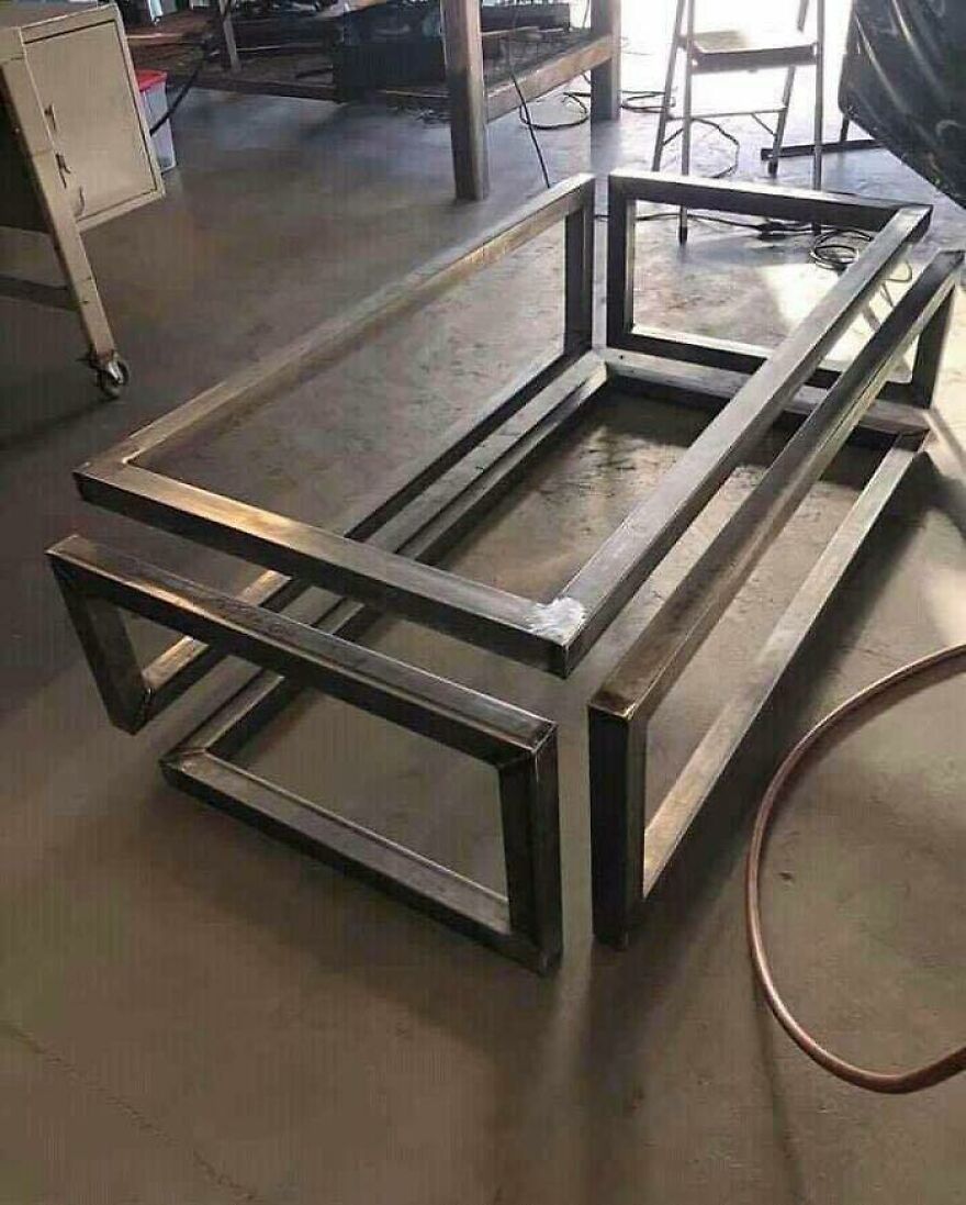 Chaotic metal frames on a floor, creating a disturbing, impossible shape, making you doubt your sanity.