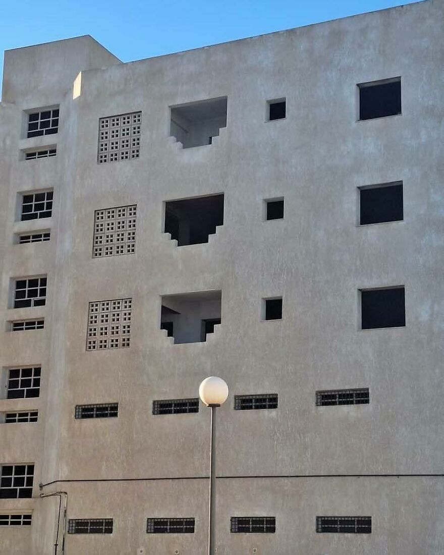 An uncomfortable and disturbing pic of a building with chaotically placed windows, making you doubt sanity.