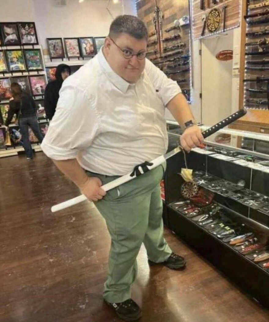 A man resembling Peter Griffin holding a katana, a chaotic and uncomfortable pic.