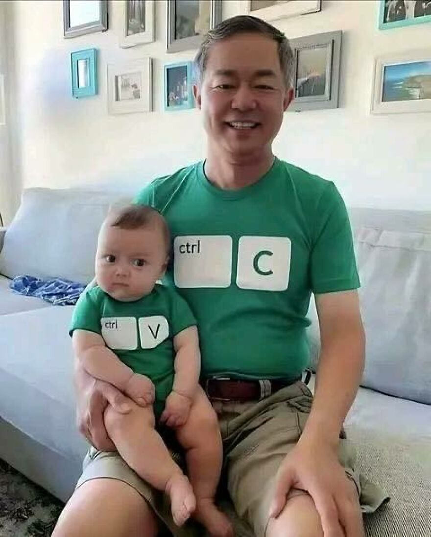 A man and a baby in matching ctrl+C and ctrl+V shirts, creating a disturbing pic.