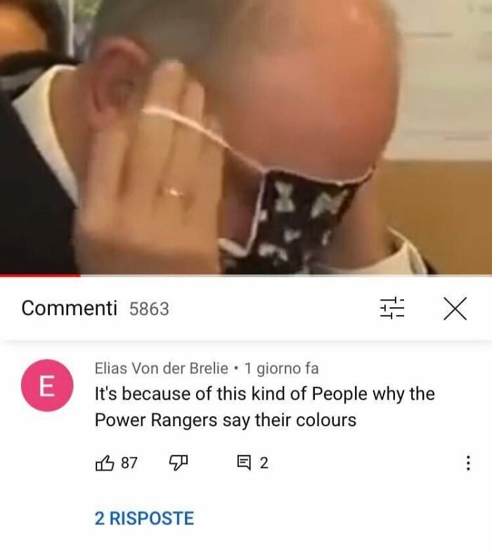 A person struggling to put on a face mask, with a humorous comment section remark about Power Rangers.