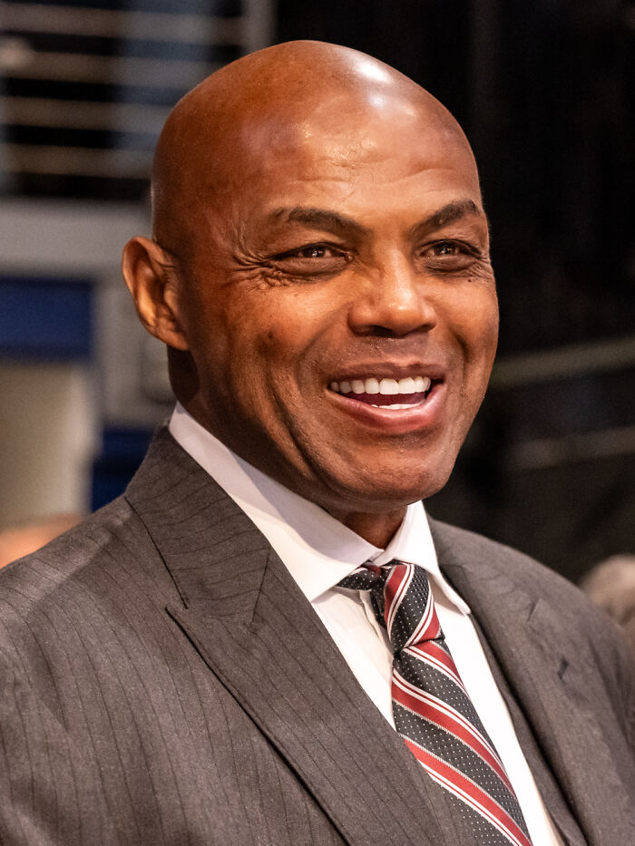 A smiling man, perhaps enjoying a delicious dinner or hot tea at a restaurant.