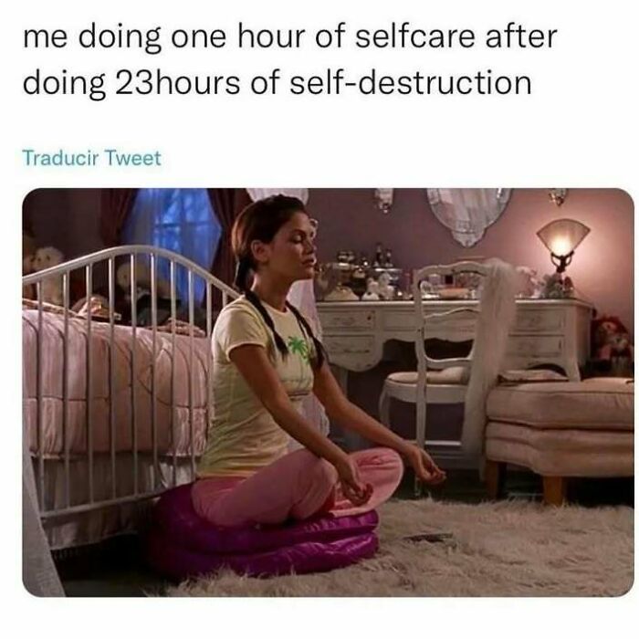 A meme for introverts of a woman meditating on a cushion, representing self-care.