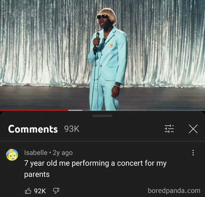 A person performing on stage in a YouTube video, with a nostalgic YouTube comment below.