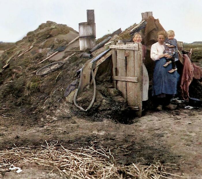 A historical colorized photo of a family standing outside a sod house, making the past come to life.