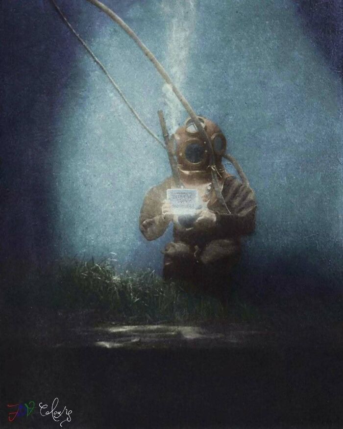 A vintage diver with a helmet and suit underwater, holding a small object. Stunning historical colorized photos.