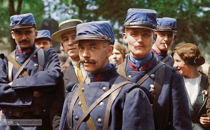 Historical colorized photos of French soldiers in blue uniforms with mustaches.