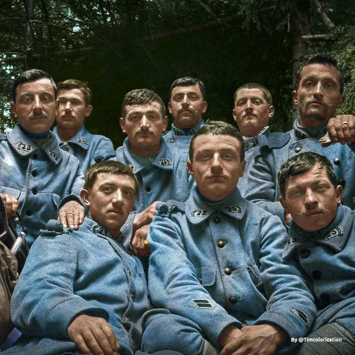 Historical colorized photos of a group of French soldiers in light blue uniforms.