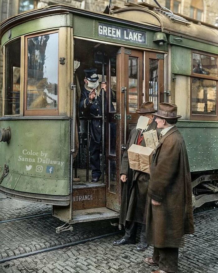 Two men talking by a tram labeled Green Lake, with a conductor visible inside, from stunning historical colorized photos.