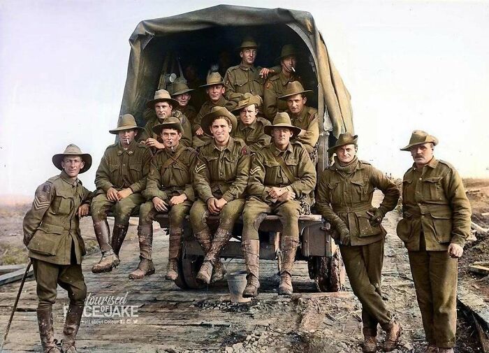 A group of soldiers in historical colorized photos, posing on and around a military truck, bringing the past to life.
