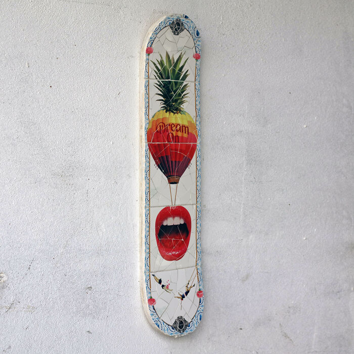 Vertical tile works with pineapple hot air balloon and open mouth on a white wall