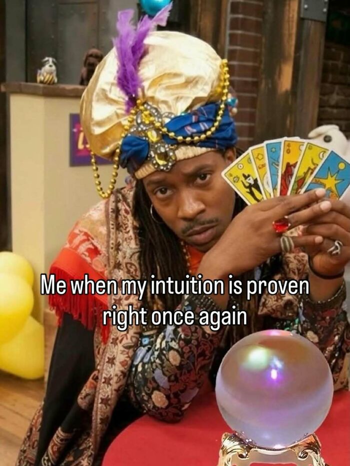 A meme of a person dressed as a fortune teller, holding tarot cards, with the text: 'Me when my intuition is proven right once again.'