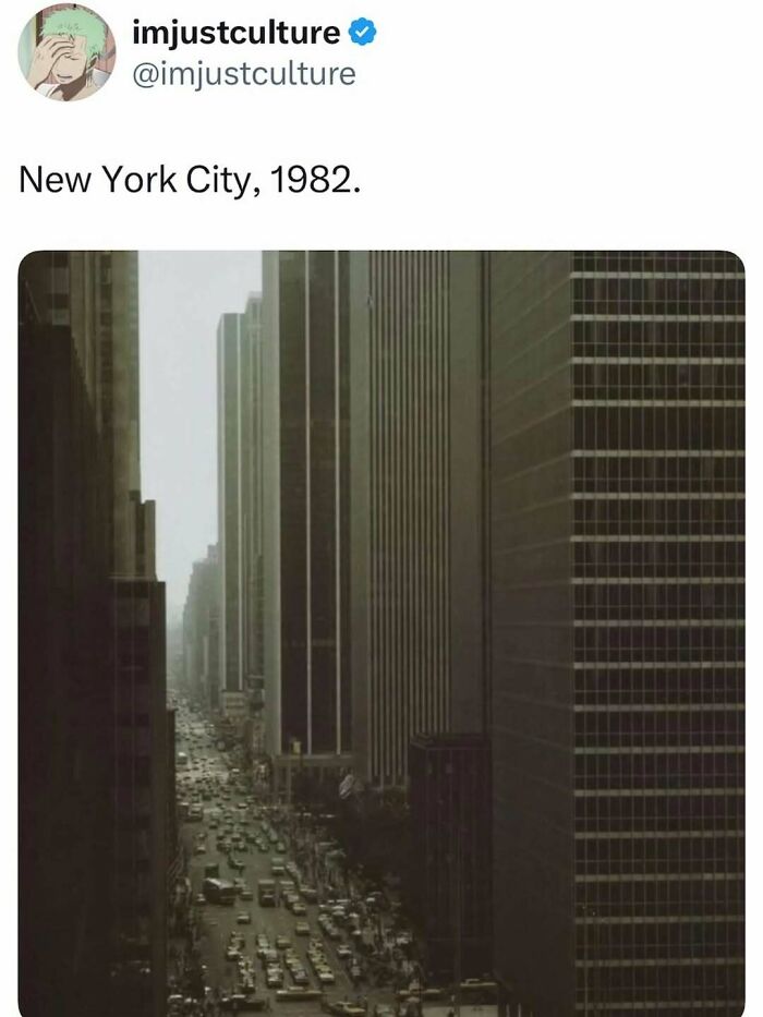 An aerial view of a bustling street in New York City in 1982, flanked by tall buildings. Imjustculture posts.