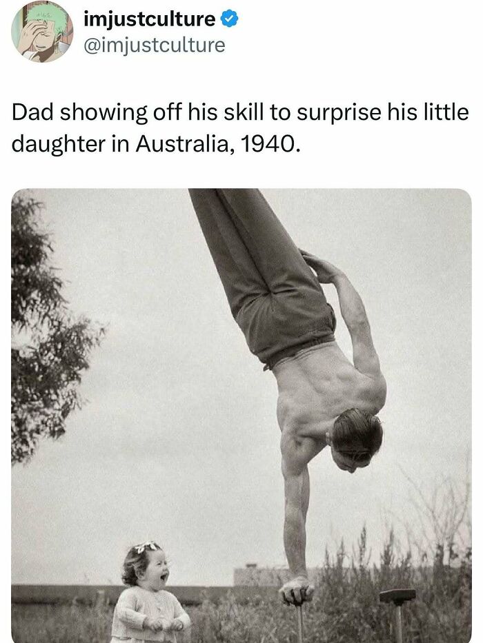 A man performing a one-arm handstand for his surprised little daughter, showcasing a dad showing off his skill.