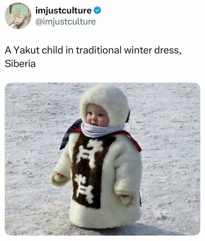 A Yakut child in a traditional, warm winter dress standing in a snowy landscape in Siberia.