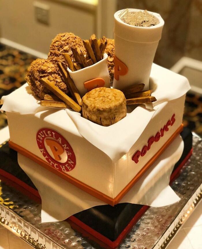 Realistic cake shaped like Popeyes fried chicken meal with fries and drink