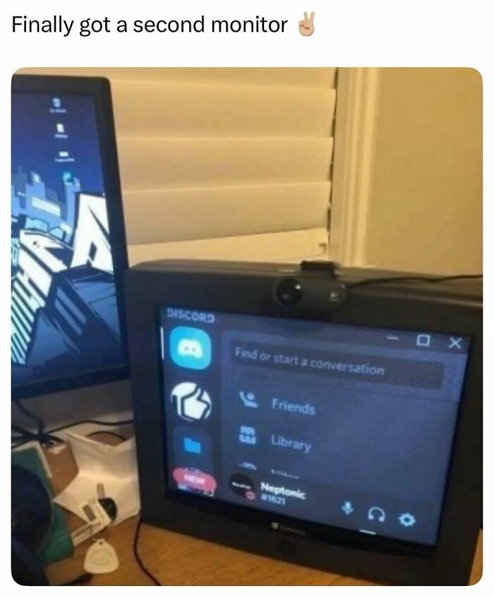A small, old-fashioned monitor displaying Discord, next to a modern monitor. A hilarious meme.