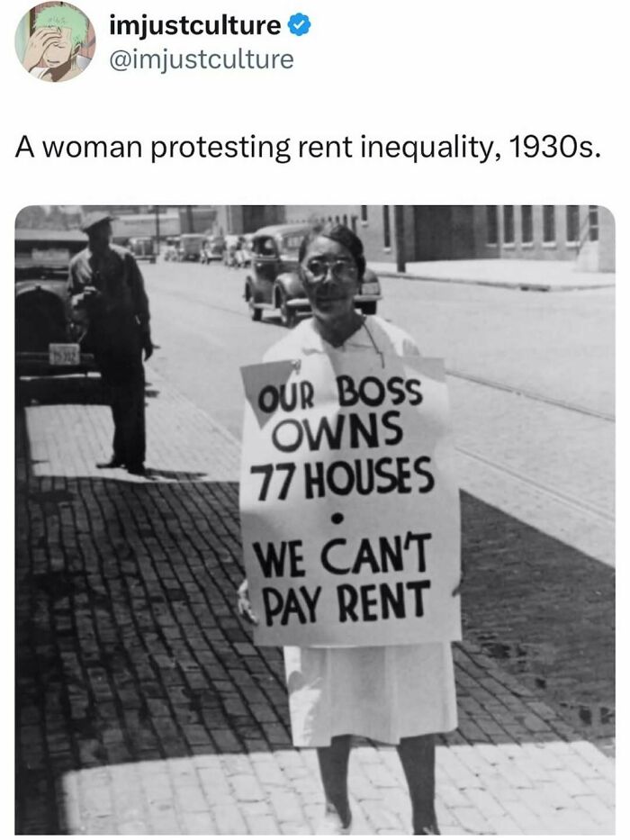 A black and white image of a woman protesting rent inequality in the 1930s, holding a sign.