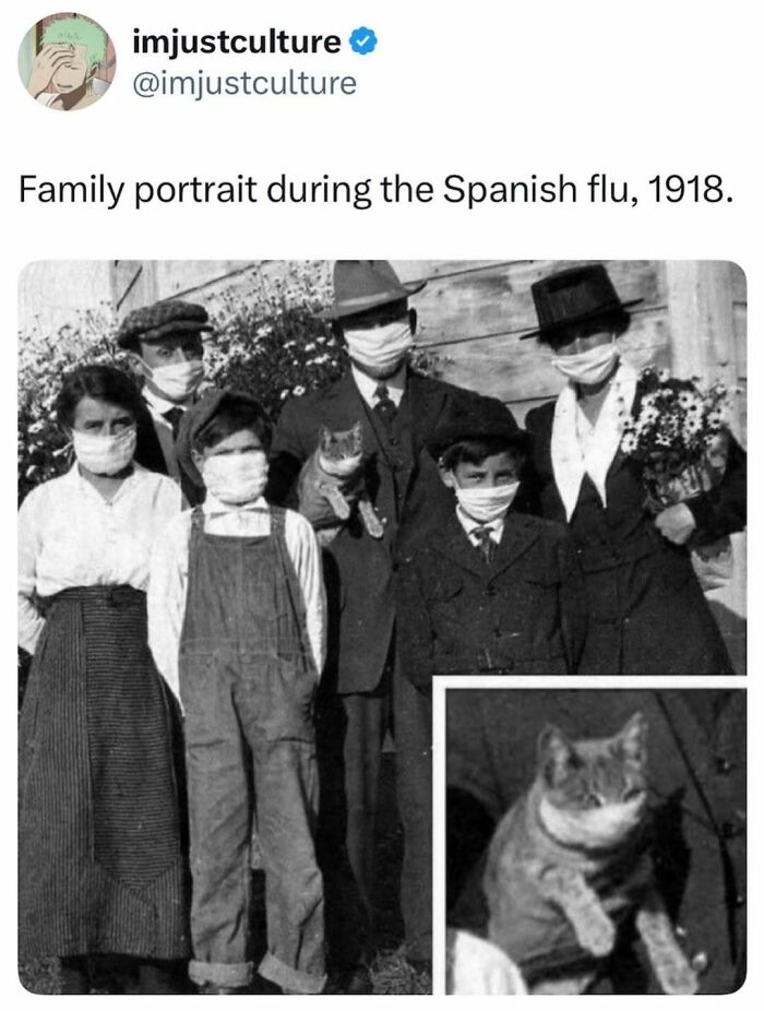 A black and white family portrait showing a family wearing face masks during the Spanish flu, including a cat.