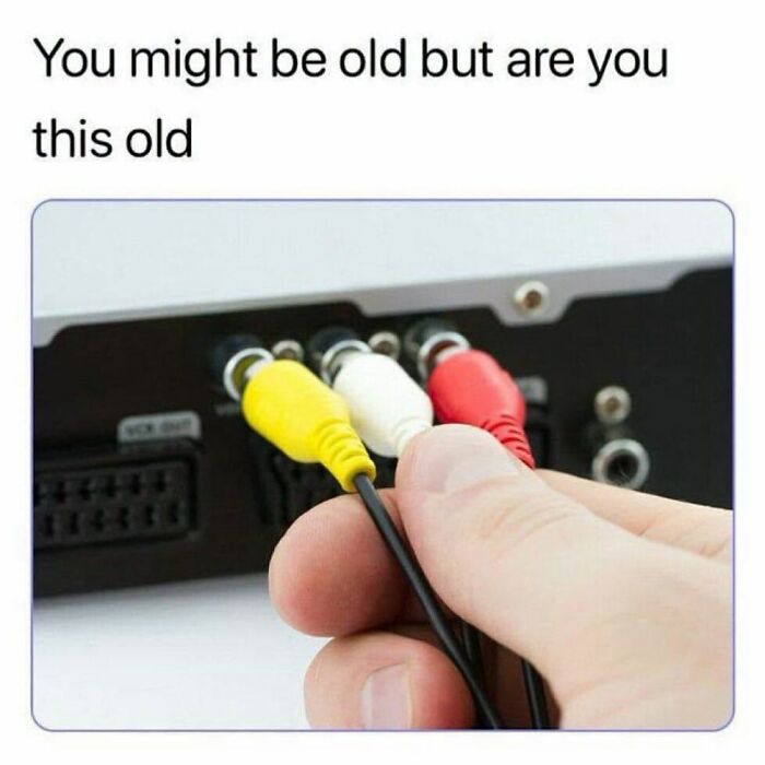 A hand plugging in yellow, white, and red RCA cables, bringing back 90s nostalgic pics memories.