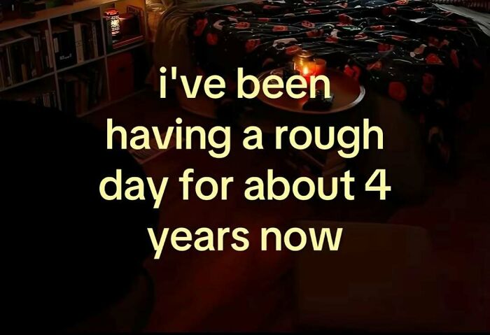 A strange internet screenshot with a quote overlaying a dark room: ive been having a rough day for about 4 years now.