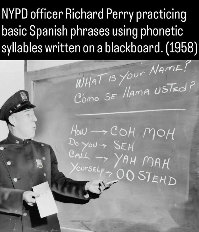An NYPD officer pointing at phonetic Spanish on a blackboard, a remarkable photo that shows the past.