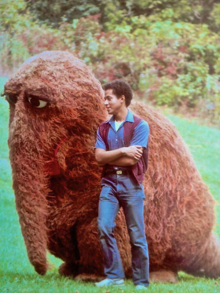 A man standing next to Snuffleupagus from Sesame Street, representing classic nostalgic 90s pics.