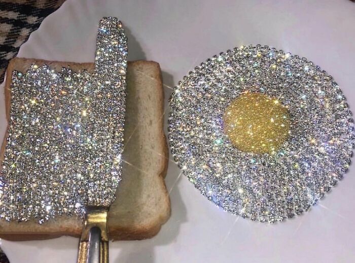Glittering jeweled spatula and fried egg on bread, unusual craftsmanship