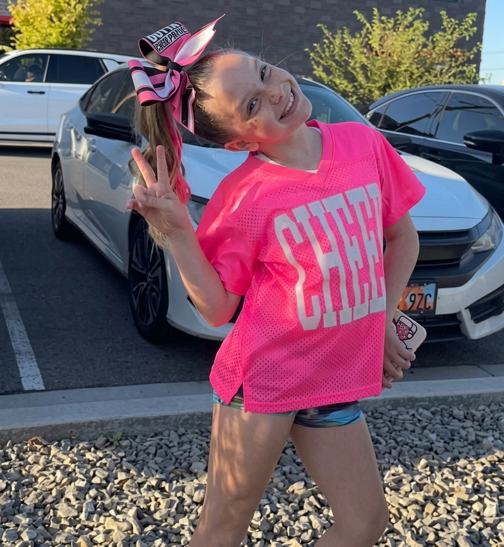 Young daughter in a pink cheerleading shirt making a peace sign, relevant to the Las Vegas hotel case. Young daughter in a pink cheerleading shirt making a peace sign, relevant to the Las Vegas hotel case.