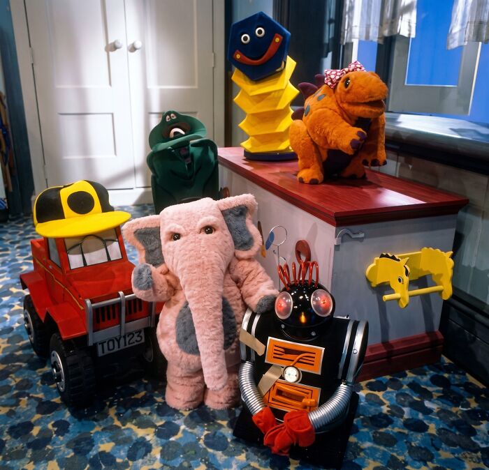 A group of nostalgic Aussie memories puppets and toys, including a pink elephant and robot, from Australian childhood.