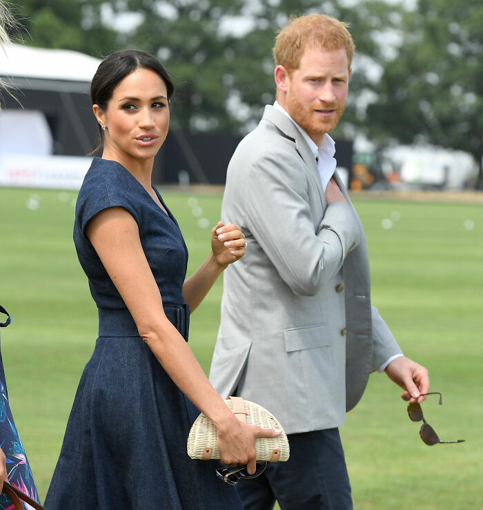 Meghan Markle and Prince Harry walking outdoors, highlighting Meghan's interview rules for household staff. Meghan Markle and Prince Harry walking outdoors, highlighting Meghan's interview rules for household staff.