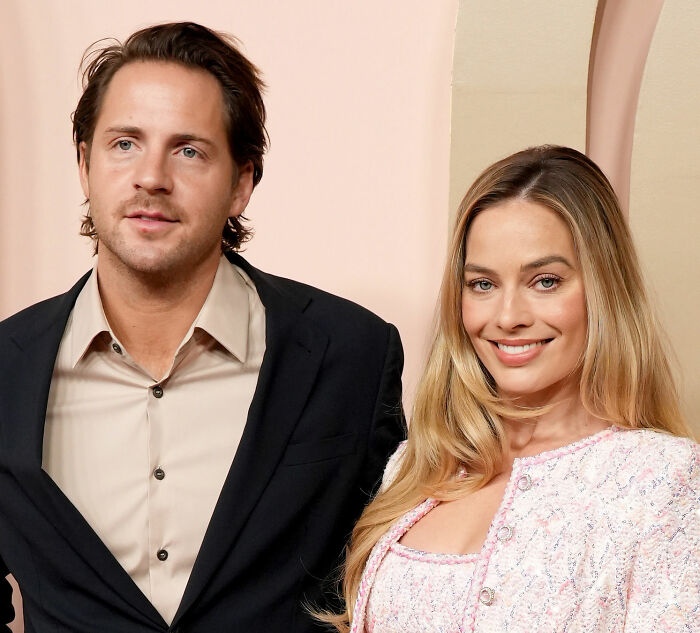 Margot Robbie and partner posing together at a formal event Margot Robbie and partner posing together at a formal event