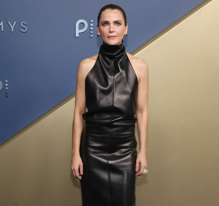 Emmy Winner's wife on the red carpet, a body language expert analyzing her demeanor.