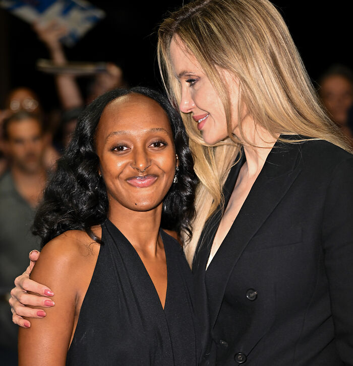 Angelina Jolie with her daughter Zahara smiling warmly together at a public event.