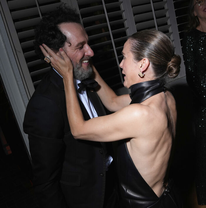 Emmy Winner and wife in a tense moment, wife touching his face.