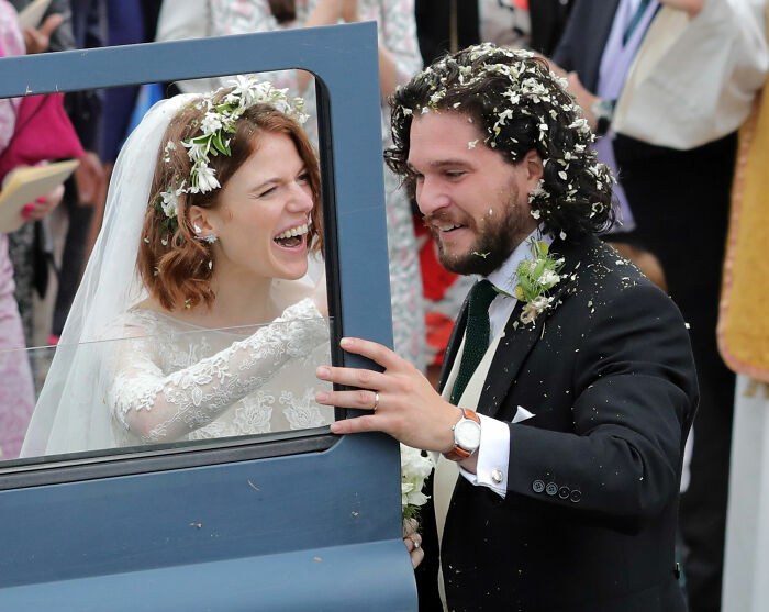 Game of Thrones star wedding scene with bride and groom covered in flower petals