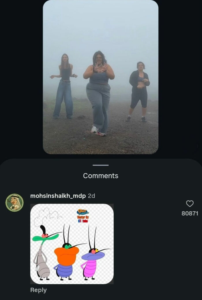 Three women dancing in a foggy landscape, with a user's comment featuring cartoon cockroach characters, a perfect reply.