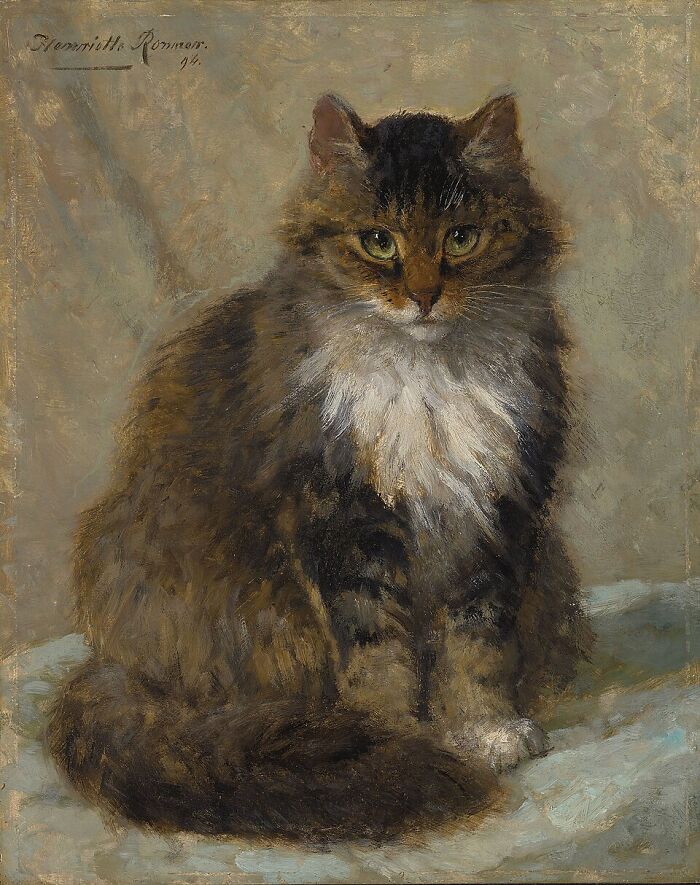 19th Century cat paintings: A fluffy tabby cat with green eyes and white chest sitting on a light blue surface.