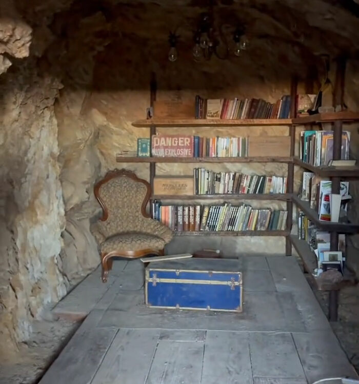 A cozy library setup inside a cave in a ghost town A cozy library setup inside a cave in a ghost town