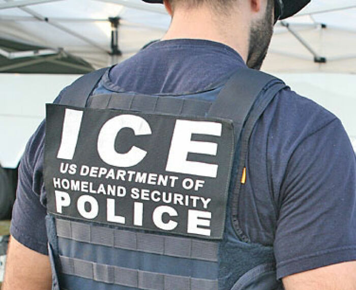 The back of an ICE US Department of Homeland Security Police officer's vest, relevant to the fence builders and their encounter. The back of an ICE US Department of Homeland Security Police officer's vest, relevant to the fence builders and their encounter.