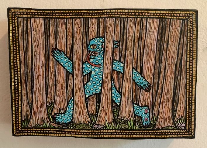 Theo Ellsworth drawing of a blue spotted monster behind tree trunks