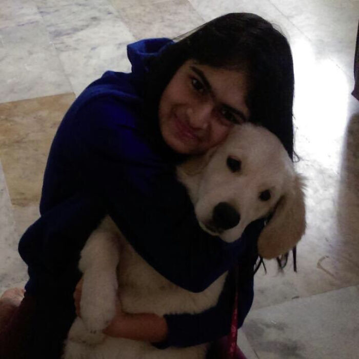 A woman embracing her dog, building a community to help other pet owners. A woman embracing her dog, building a community to help other pet owners.