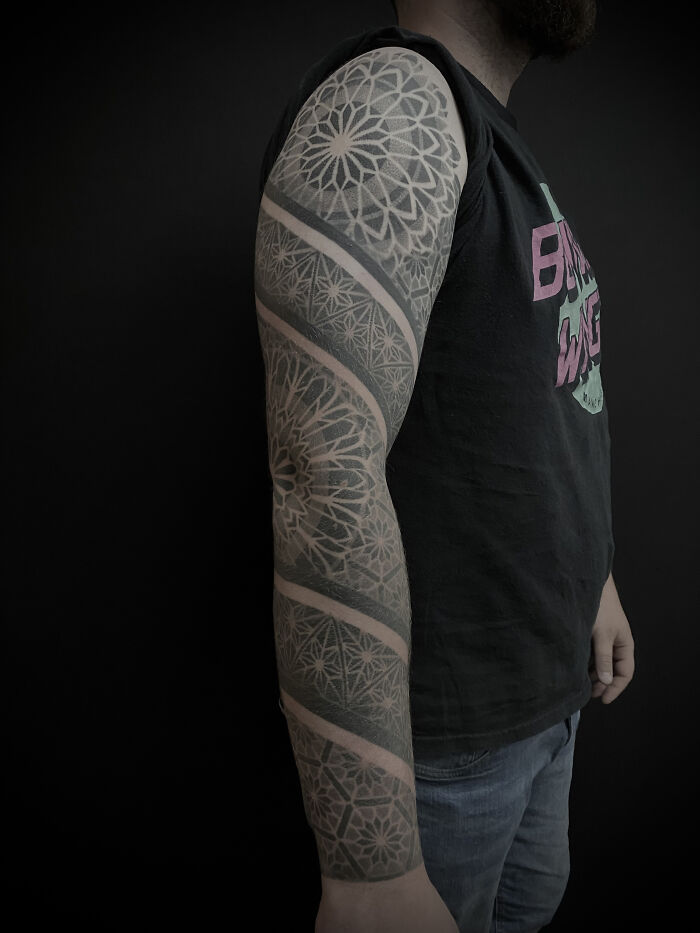 A stunning arm tattoo inspired by spiritual geometry, showcasing intricate patterns from Sacred Gold Studio.