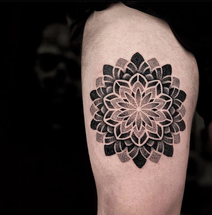 A stunning sacred geometry tattoo of a mandala on a thigh, a beautiful piece from Sacred Gold Studio.